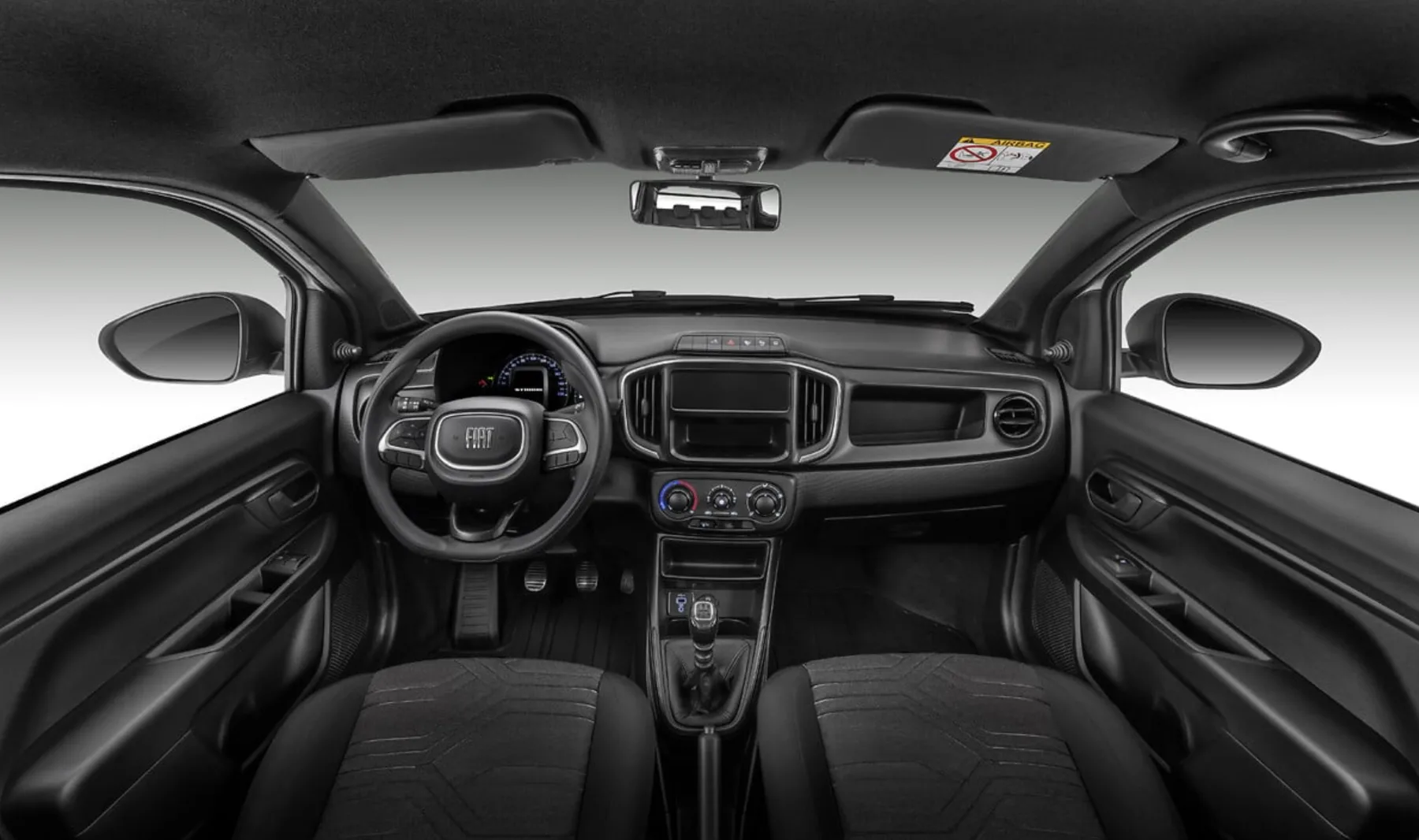 O interior simples inclui ar-condicionado, direção elétrica e volante ajustável, garantindo conforto básico e boa ergonomia, sem abrir mão da resistência necessária para o trabalho intenso.